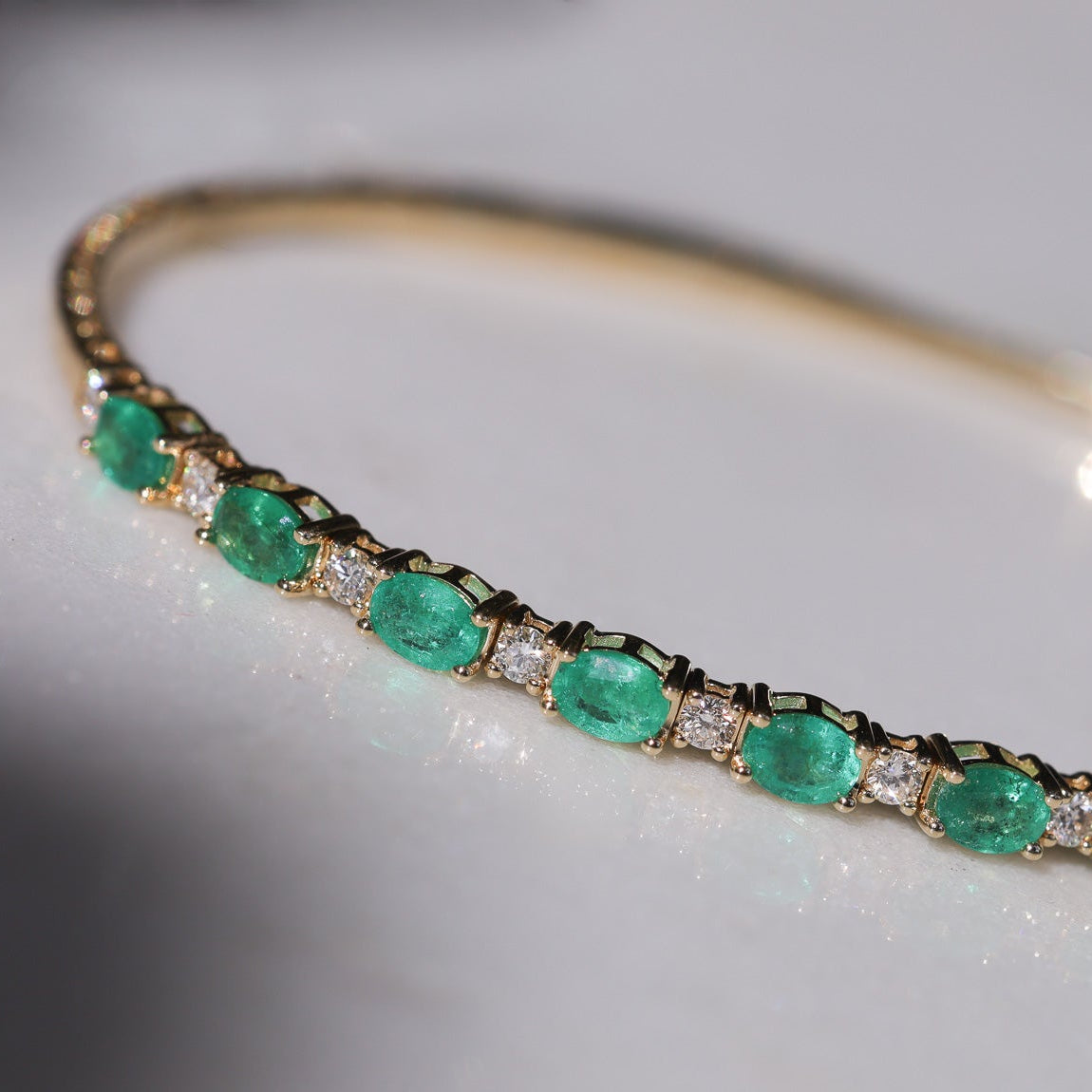 Alternating East to West Set Oval Emerald and Round Diamond Flexible Bangle Bracelet
