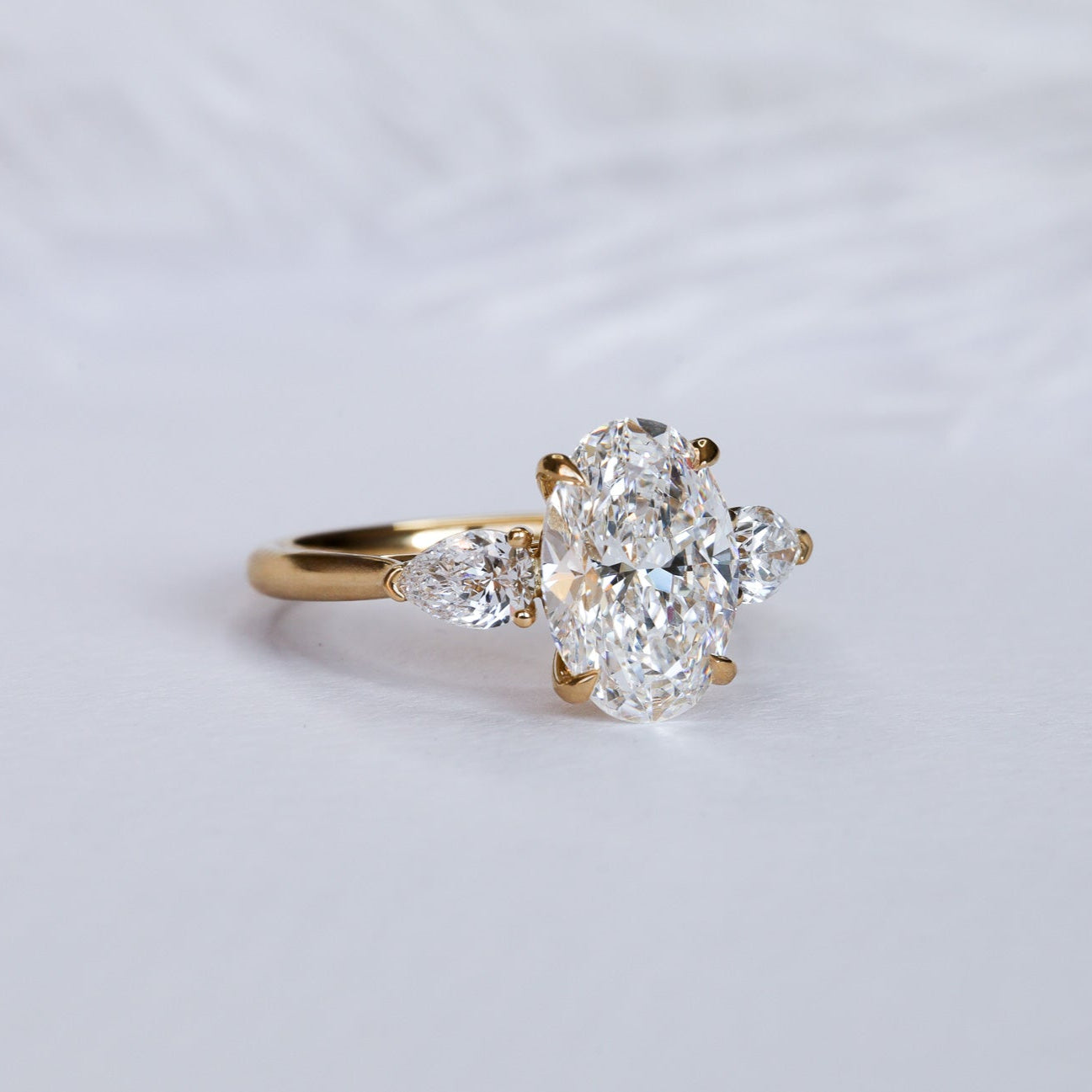 Engagement Ring Three Stones Oval Surrounded by Pears