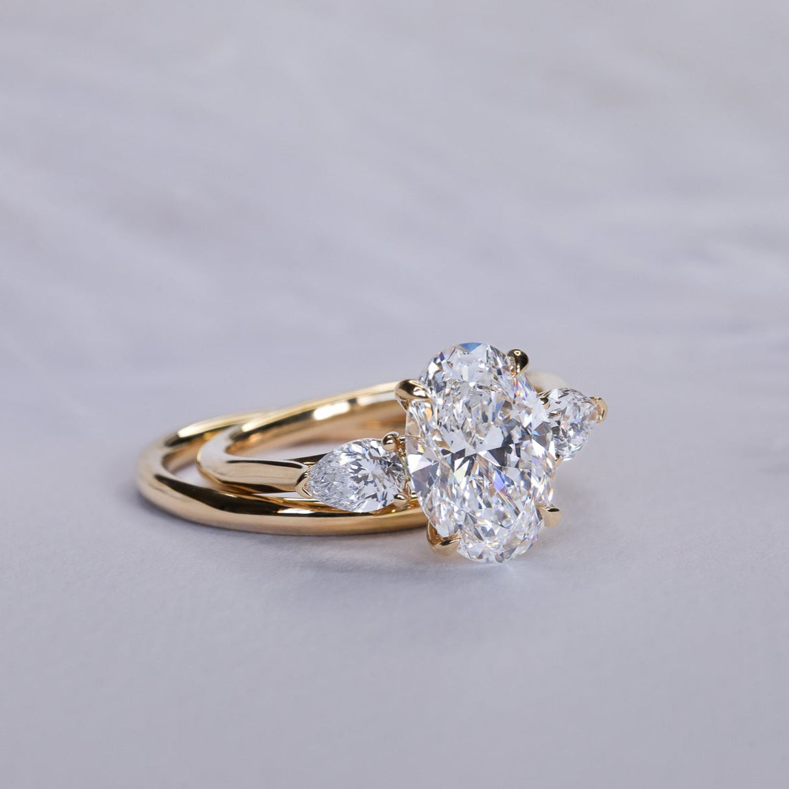 Engagement Ring Three Stones Oval Surrounded by Pears