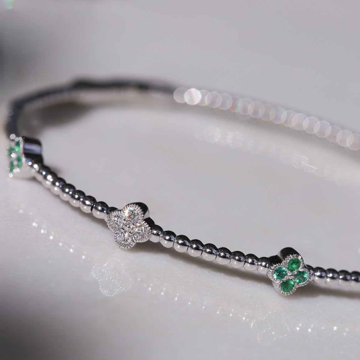 White Gold Stationed Clover Diamond and Emerald Flexible Bangle